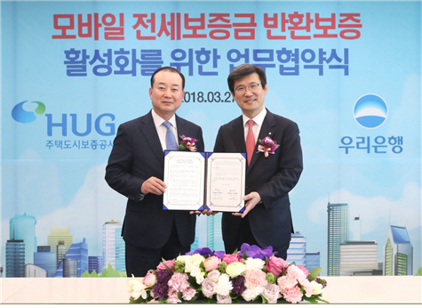 김기돈(왼쪽) 주택도시보증공사(HUG) 금융사업본부장과 이창재(오른쪽) 우리은행 부동산금융그룹 부행장이 27일 ‘모바일 전세보증금 반환보증 활성화를 위한 업무 협약식’을 가지고 기념촬영을 하고 있다. / 사진=HUG 제공