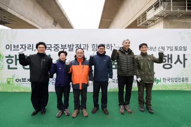 신용준(왼쪽 세번째) 이브자리 부회장, 김인숙(〃 두번째) 서울시 한강사업본부 공원부장, 정승교(〃네번째) 한국중부발전 기술부사장 직무대행 등 관계자들이 지난 7일 서울 강서 한강공원에서 ‘한강 탄소상쇄숲 조성 행사’에서 기념 촬영을 하고 있다. 도시숲 조성을 통해 탄소상쇄와 미세먼지 저감에 기여하기 위해 진행된 이날 행사에서 이브자리 임직원과 시민 1,000명이 포플러나무를 심고 소원을 적은 명패를 걸었다. /사진제공=이브자리