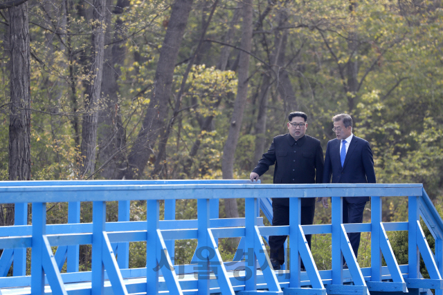 문재인 대통령과 김정은 국무위원장은 공동 식수를 마친 후 군사분계선 표식물이 있는 ‘도보다리’까지 산책을 하며 담소를 나누고 있다. /한국공동사진기자단