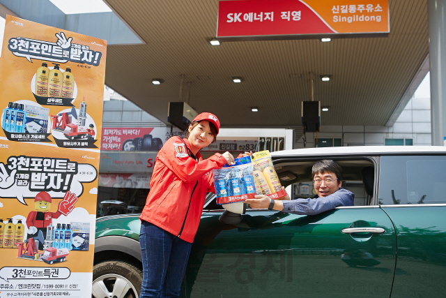 서울 신길동 SK에너지 직영 주유소에서 SK직원이 주유 고객에게 ‘3,000포인트특권’ 행사로 제공되는 경품을 전달하고 있다. /사진제공=SK이노베이션