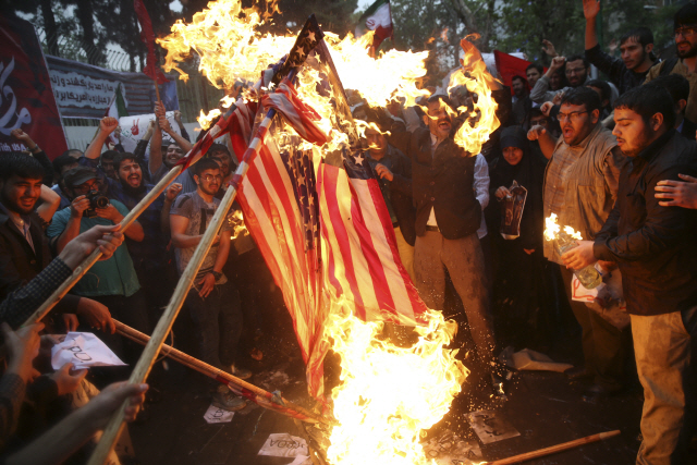 9일(현지시간) 이란의 보수성향 시민들이 수도 테헤란에 위치한 미국대사관 자리에 모여 성조기를 불태우고 있다.  /AP연합뉴스