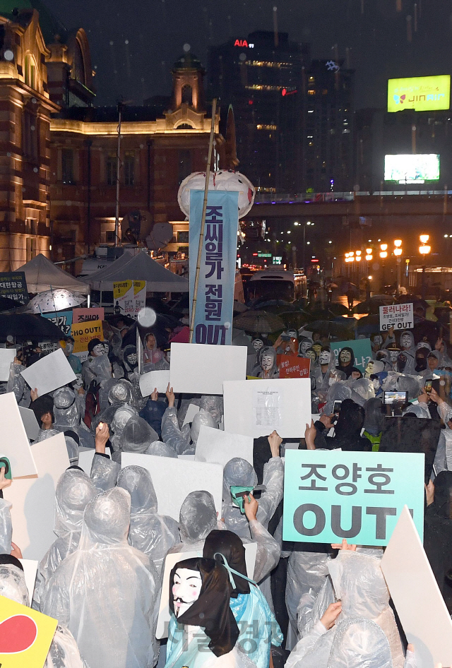 12일 오후 서울역 광장에서 대한항공 직원연대가 조양호 회장 일가 퇴진과 갑질 근절을 위한 2차 촛불집회열고, '조씨일가 전원 OUT' 문구를 보이는 퍼포먼스를 하고 있다. /이호재기자.