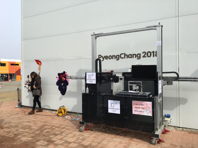 아트봇이 지난 2018 평창 동계올림픽에서 경기장 주변의 벽면에 마스코트를 그리는 시연을 하고 있다./사진제공=로보프린트