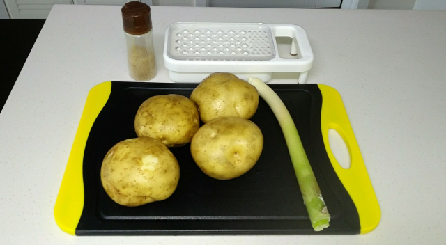 감자전 요리를 위해 감자 4개와 대파, 소금을 준비한다. 그리고 감자를 갈아주기 위해 강판을 꺼내 놓는다.
