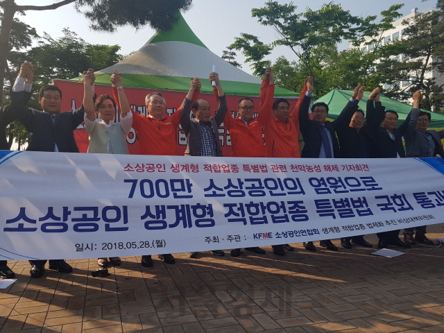 소상공인연합회가 28일 연 ‘소상공인 생계형 적합업종 특별법 관련 천막농성 해제 기자회견’에서 최승재(오른쪽 다섯번째) 소상공인연합회 회장을 비롯한 소상공인연합회 관계자들이 생계형 적합업종 특별법 통과에 만세를 부르고 있다./ 심우일기자