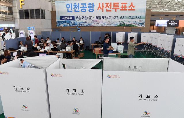 제7회 전국동시지방선거 사전투표일 하루 앞둔 7일 오전 인천국제공항 제1여객터미널 사전투표소에서 선관위직원과 공무원들이 투표소를 설치하고 있다./서울경제DB