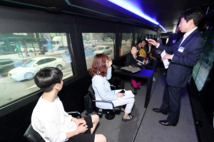 KT 관계자가 자사의 자율주행 버스에 탑승한 시민들에게 자율주행 기술을 설명하고 있다./사진제공=KT