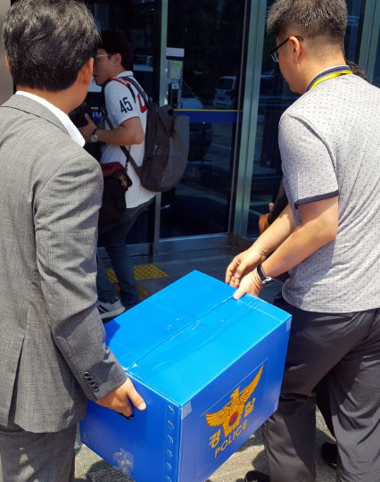 지난 17일 ‘고3 시험지 유출 사건’을 수사하는 광주 서부경찰서 소속 수사관이 사건이 발생한 광주 한 고등학교에서 챙겨온 압수품을 옮기고 있다./연합뉴스