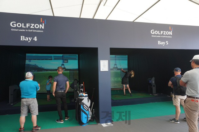 브리티시 오픈을 찾은 관람객들이 대회장 부스에 마련된 골프존 시스템에서 스크린골프를 체험해고 있다.