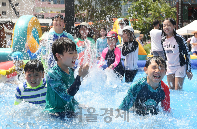 폭염이 계속되는 29일 서울 종로구 견지동 조계사 경내에 마련된 물놀이장에서 여름방학을 맞아 여름불교학교에 참가한 어린이들이 물놀이를 하며 더위를 이겨내고 있다./권욱기자