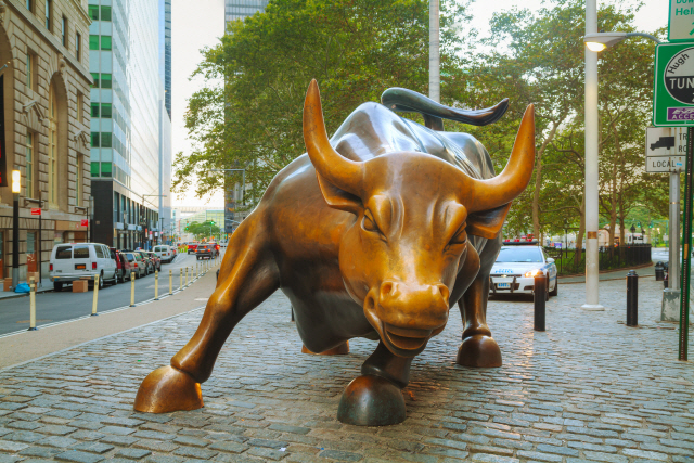 NEW YORK CITY - September 5: Charging Bull sculpture on September 5, 2015 in New York City. The sculpture is both a popular tourist destination, as well as “one of the most iconic images of New York”.
