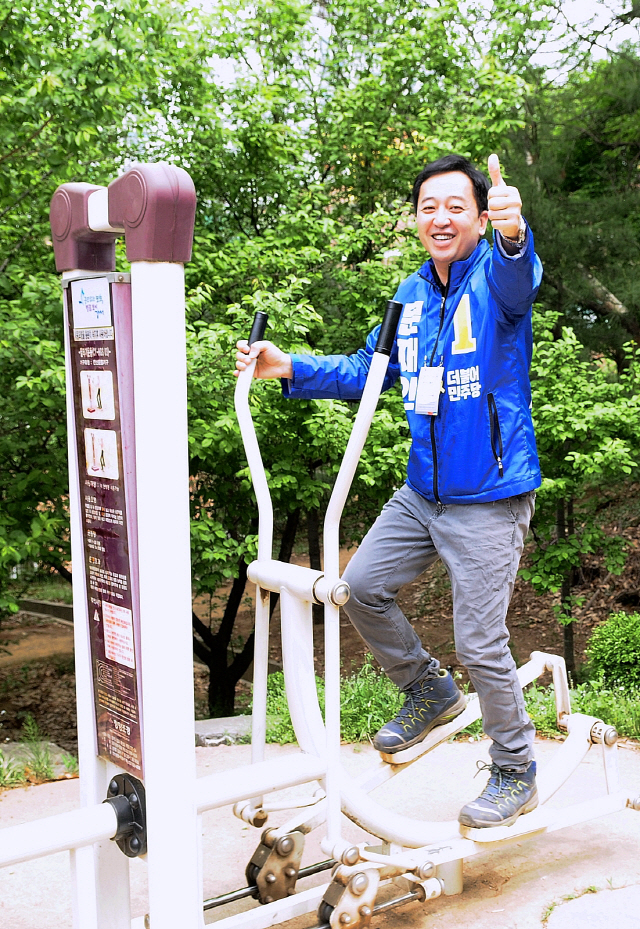 금태섭 의원이 야외에서 운동을 하며 엄지손가락을 치켜세우고 있다.