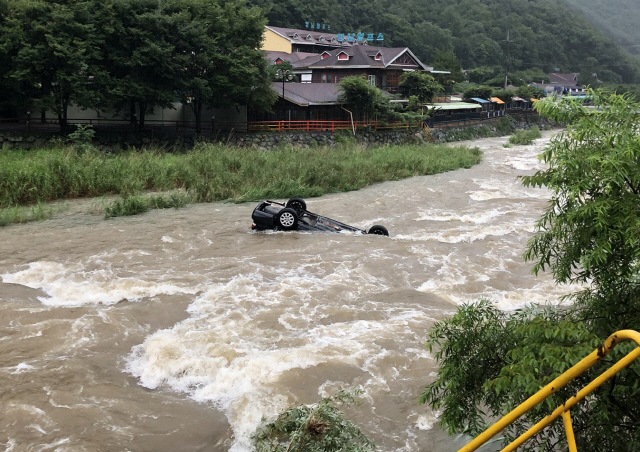 26일 호우경보가 발효된 울산시 울주군 상북면 계곡에서 승용차 한 대가 갑자기 불어난 물살에 휩쓸려 떠내려가고 있다. 이날 경남 산청과 전남 구례 등에는 300mm 안팎의 폭우가 쏟아져 계곡이 범람하고 도로가 침수되는 등 피해가 잇따랐다. 기상청은 27일까지 경기 남부, 강원 남부, 충청 북부 등 일부 지역에 최대 200mm에 달하는 비가 쏟아질 것으로 예보했다. /울산=연합뉴스