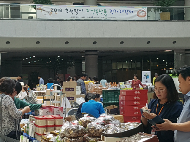 정부대전청사 지하 1층 로비에서 열리고 있는 ‘추석맞이 폭염피해농가돕기 직거래장터’에서 청사입주기관직원들이 진열된 상품을 둘러보고 있다. 사진제공=정부대전청사관리소