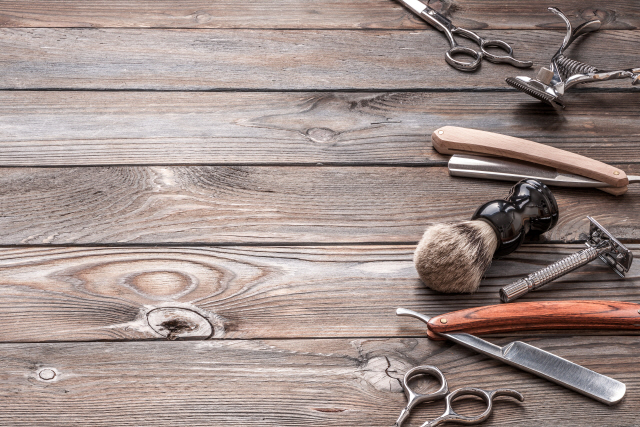 Vintage barber shop tools on old wooden background