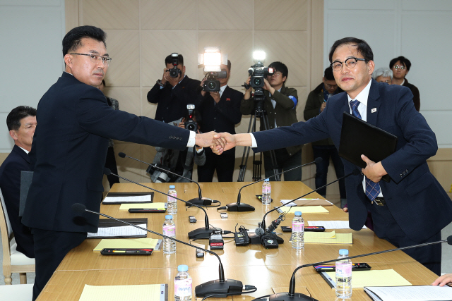 남북 산림협력 회담 남측 수석대표를 맡은 박종호 산림처 차장(오른쪽)과 북측 수석대표를 맡은 김성준 국토환경보호성 산림총국 부총국장이 22일 저녁 회담 종결회의에서 끝맺음 인사를 마친 뒤 악수하고 있다./연합뉴스