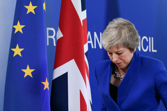 테리사 메이 영국 총리가 25일 유럽연합(EU) 특별정상회의 기자회견을 마친 후 착잡한 심정으로 행사장을 떠나고 있다.  /브뤼셀=AFP연합뉴스