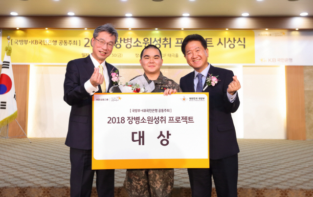 30일 서울 용산구 국방부 육군회관에서 열린 ‘2018 장병소원성취 프로젝트 시상식’에서 허인(왼쪽부터) KB국민은행장, 박필원 상병, 서주석 국방부 차관이 포즈를 취하고 있다./사진제공=국민은행