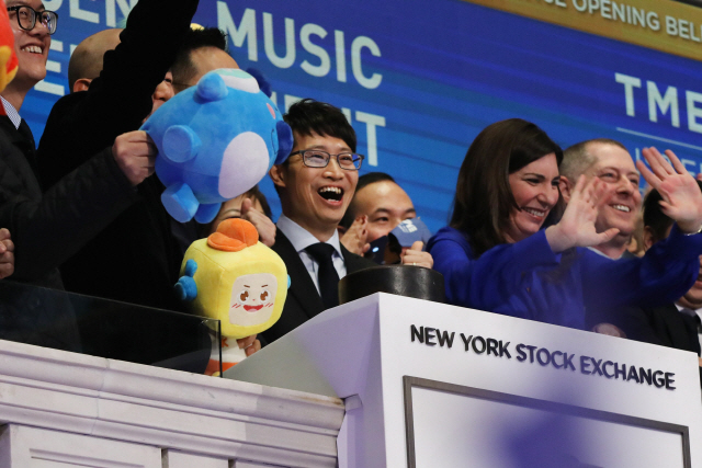 펑자신(가운데) 텐센트 뮤직엔터테인먼트 최고경영자(CEO)가 12일(현지시간) 미 뉴욕증권거래소(NYSE)에서 상장한 뒤 기뻐하고 있다. /뉴욕=AFP연합뉴스