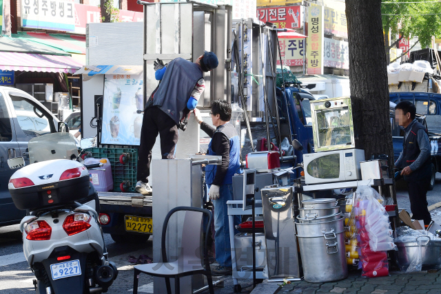 지난 2일 서울 중구 황학동 주방용품 거리에서 관계자들이 폐업 점포에서 나온 업소용 조리 기구와 용품들을 정리하고 있다./권욱기자
