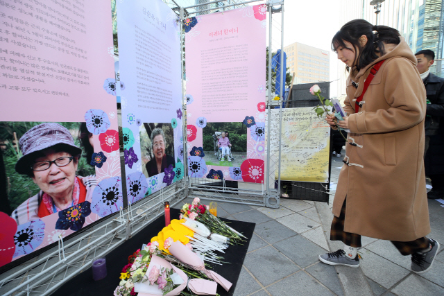 2018년 마지막 ‘일본군성노예제 문제해결을 위한 정기수요시위’가 열린 26일 서울 종로구 옛 일본대사관 앞에서 사람들이 돌아가신 위안부 할머니들에게 헌화하고 있다./연합뉴스