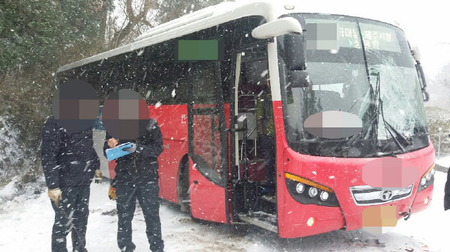 제주 산지에 많은 눈이 내린 28일 오후 제주시 아라동 516도로에서 시외(간선)버스가 빙판길에 미끄러져 마주 오던 버스와 충돌하는 사고가 난 현장에서 119 구급대 등이 현장 정리를 하고 있다./제주도소방안전본부 제공=연합뉴스