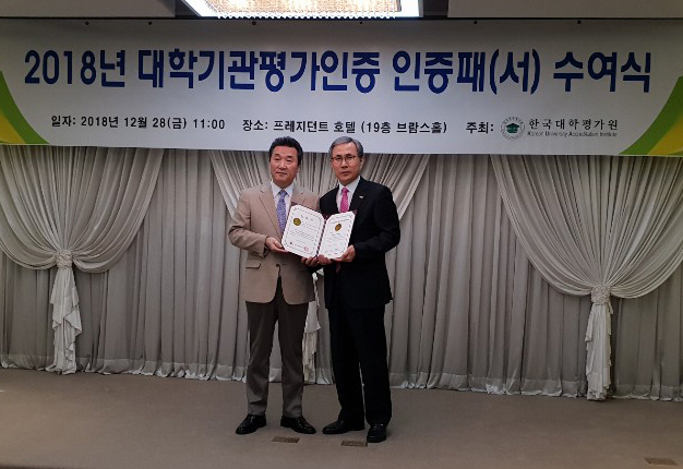 김용호(오른쪽) 와이즈유 교무처장이 28일 ‘대학기관평가인증 수여식’에서 인증패를 받고있다./사진제공=와이즈유