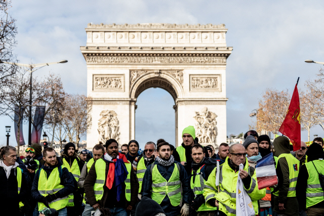지난해 12월 8일(현지시간) 파리 샹젤리제 거리 개선문 앞에서 ‘노란조끼’ 시위대가 행진 하고 있다. /블룸버그