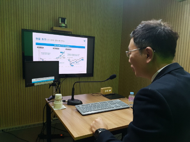 김범준 삼성증권 리서치센터 글로벌투자전략팀 수석연구원이 지난달 31일 서울 서대문구의 한 온라인 방송 스튜디오에서 이 증권사가 ‘해외투자 2.0시대의 투자전략’을 주제로 처음 진행한 실시간 인터넷 방송에서 시청자의 질문(작은 모니터)을 읽고 있다. /조양준기자