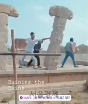 유네스코 세계 문화유산 보호지역인 인도 남부 함피에서 유적 기둥을 밀어 넘어뜨리는 인도 청년. /사진=유튜브 영상 캡처