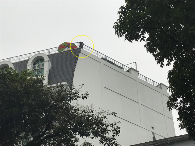 북미 정상회담 첫째날인 27일 오전 회담장인 소피텔 레전드 메트로폴 호텔 인근 고층건물에 베트남 군인(노란색 원 안)이 경계근무를 서고 있다. /하노이=이태규기자