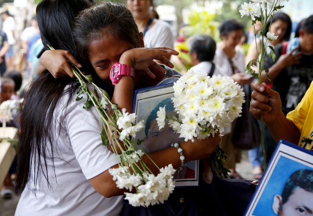 17일(현지시간) 필리핀의 로드리고 두테르테 대통령이 선포한 ‘마약과의 전쟁’으로 살해된 사망자들의 가족들이 모여 눈물을 흘리고 있다./AP연합뉴스