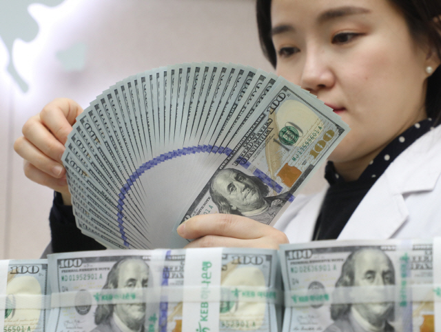 시중은행의 한 직원이 달러화를 검수하고 있다. 한국은행은 29일 지난해 하반기 외환시장에서 달러화를 약 1억9,000만 달러 순매도했다고 발표했다./연합뉴스