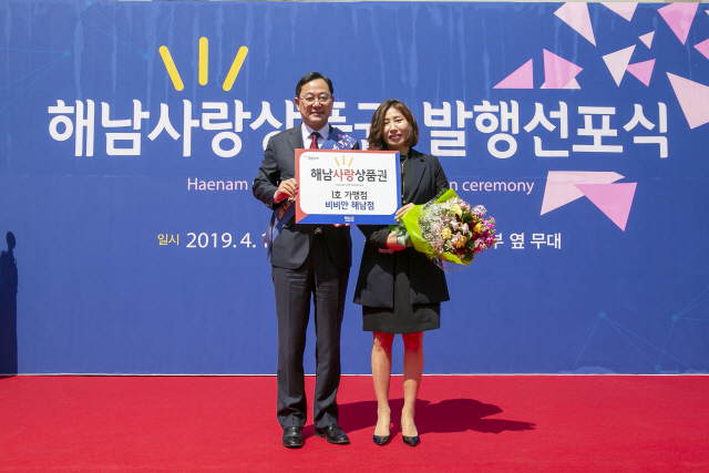 명현관(왼쪽) 해남군수가 17일 해남사랑상품권 발행 선포식을 갖고 1호 가맹점 대표에게 지정서를 전달하고 있다. /사진제공=해남군