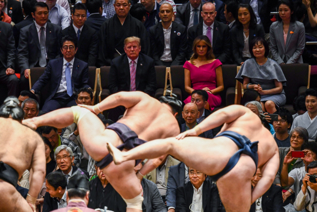 도널드 트럼프(왼쪽 두번째) 미국 대통령 부부가 아베 신조(왼쪽) 일본 총리 부부와 함께 26일 도쿄 료고쿠에 위치한 스모경기장 고쿠기칸에서 스모를 관람하고 있다.    /도쿄=로이터연합뉴스