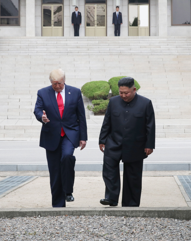 도널드 트럼프 미국 대통령과 북한 김정은 국무위원장이 30일 오후 판문점 군사분계선을 넘고 있다. /연합뉴스