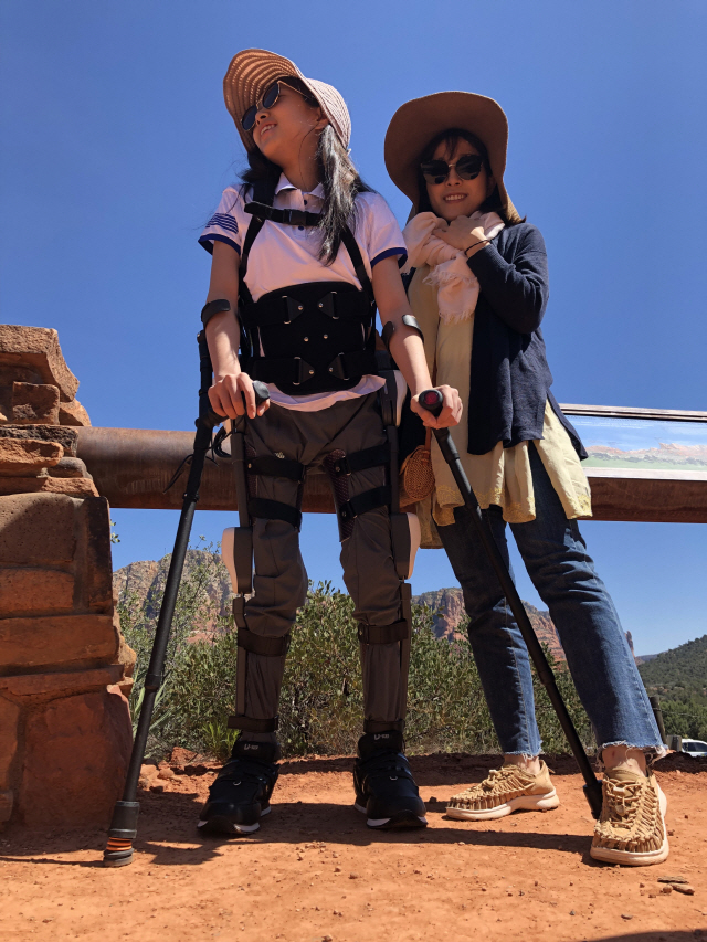 지난 3월 박채이(왼쪽)양이 웨어러블로봇 ‘엔젤슈트’를 착용하고 미국 애리조나주의 한 리조트 주변 사막 위를 걷고 있다. /사진제공=엔젤로보틱스