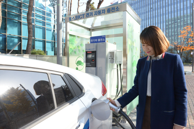 한 시민이 포스코ICT의 전기차 충전기를 이용해 전기배터리를 충전하고 있다./서울경제