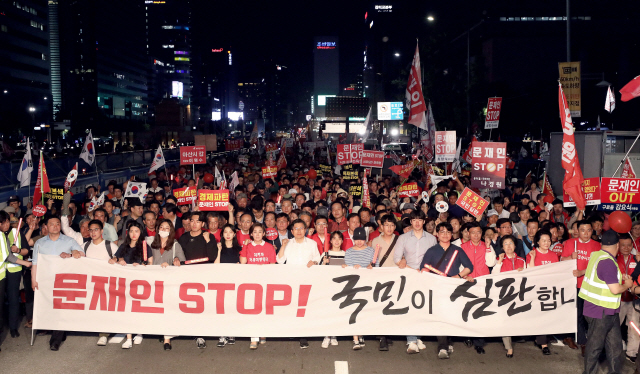 지난 5월25일 서울 광화문에서 열린 자유한국당 장외집회에서 한국당 관계자들이 현수막을 들고 행진하고 있다. /연합뉴스