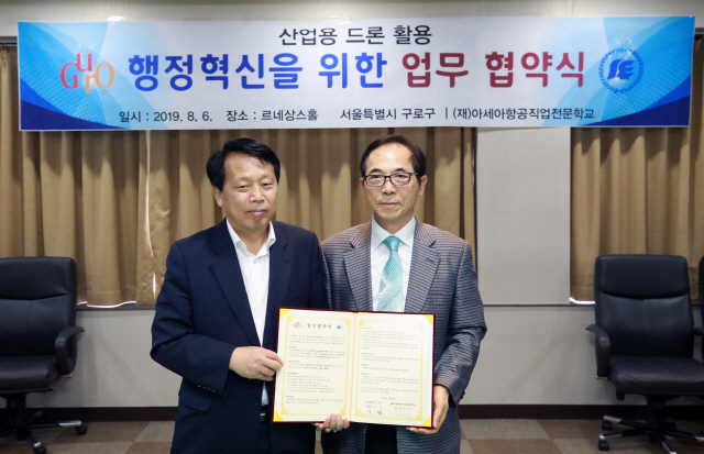 이성(왼쪽) 구로구청장과 서석주 아세아항공직업전문학교 학장이 지난 6일 구로구청에서 드론활용 행정 시범사업을 양 기관이 함께 추진하는 내용의 MOU를 체결하고 이를 들어보이고 있다.      /사진제공=구로구