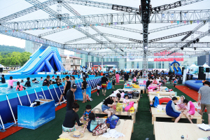 ‘여름 풀(Pool) 축제’에 참가한 관광객들이 초대형 텐트 아래에서 휴가를 즐기고 있다./제공=문화엑스포