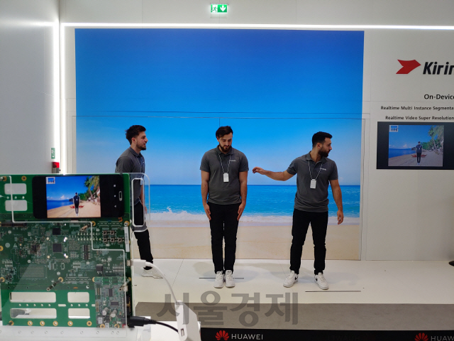 화웨이 관계자들이 독일 베를린에서 열린 유럽 최대 가전전시회 IFA2019 화웨이 전시장에서 5G폰용 통합칩 ‘기린 990’을 이용한 AI 영상 촬영 시범을 보이고 있다./권경원기자