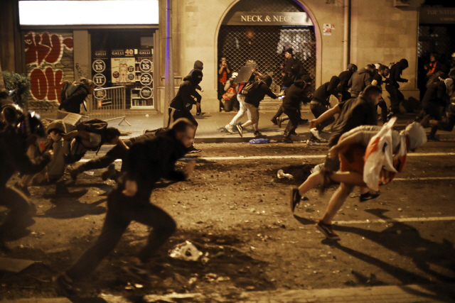 스페인 바르셀로나에서 17일(현지시간) 시위자들이 경찰을 피하고 있다. /바르셀로나=AP연합뉴스