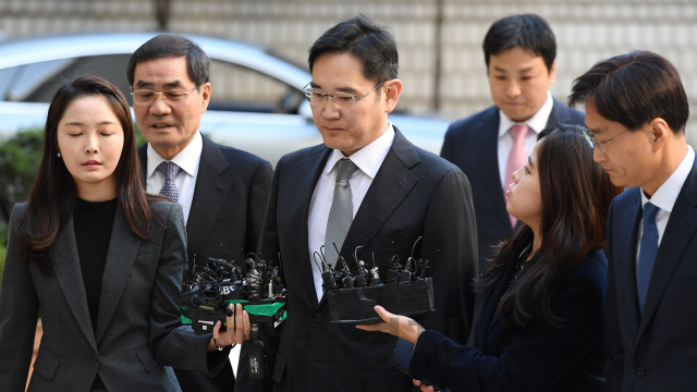 이재용(가운데) 삼성전자 부회장이 25일 서울 서초구 서울고등법원에서 진행된 뇌물공여 등 혐의에 대한 파기환송심 첫 공판에 출석하고 있다.  /오승현기자