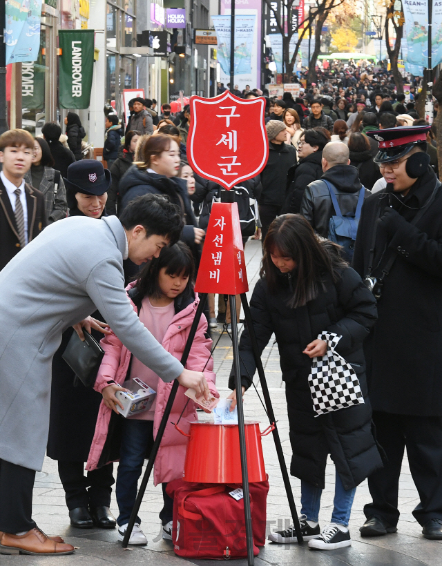 구세군 한국군이 시종식을 시작으로 전국 353곳에서 거리모금에 돌입한 29일 오후 서울 중구 명동에서 어린이가 자선냄비에 성금을 넣고 있다./오승현기자 2019.11.29