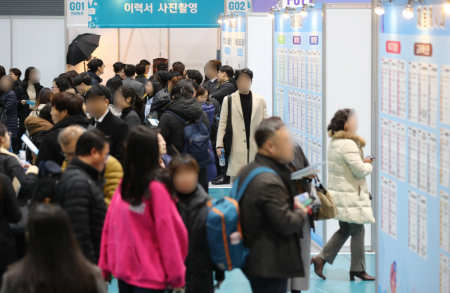지난달 26일 서울 강남구 세텍(SETEC)에서 열린 ‘2019 서울형 뉴딜일자리 참여자 채용박람회’에서 구직자들이 채용공고를 살펴보고 있다. /연합뉴스