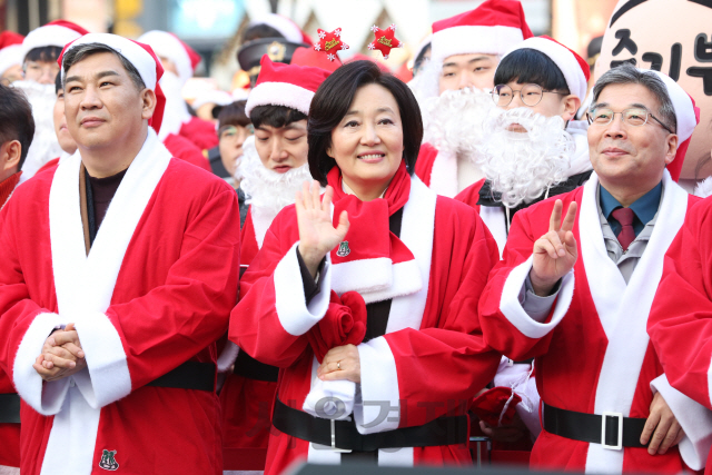 박영선(가운데) 중소벤처기업부 장관이 24일 ‘가치삽시다 크리스마스 마켓’ 행사가 진행 중인 서울 신촌 연세로에 열린 한국청소년재단의 ‘2019 몰래 산타’ 출정식에 산타 복장을 하고 참석해 기념촬영을 하고 있다. 지난 2006년부터 시작된 몰래 산타 행사는 산타 복장을 한 자원봉사자가 크리스마스 이브에 소외계층 아동과 청소년을 찾아가는 행사다. 그동안 1만3,217명의 산타가 1만,2689명의 아이들을 만났다. /사진제공=중기부