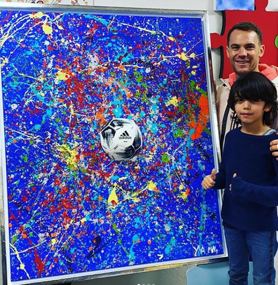 8세 미술 신동 미카일 아카르(앞쪽)와 독일 축구스타 마누엘 노이어가 지난해 11월 열린 전시회에서 자신들이 함께 그린 그림 앞에서 포즈를 취하고 있다. /아카르 인스타그램 캡처