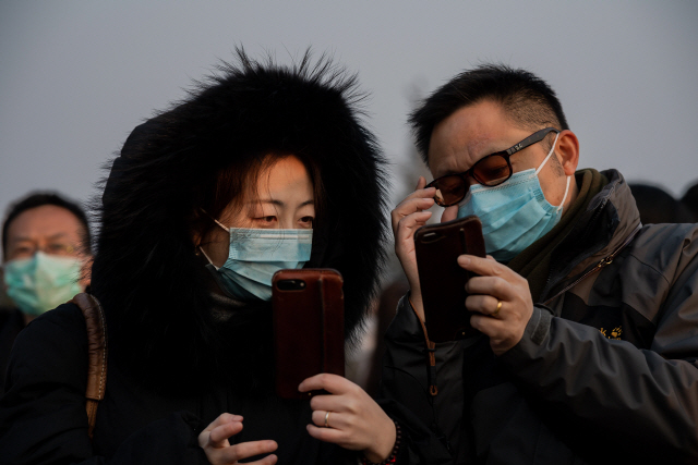 25일(현지시간) 중국 베이징 시민들이 마스크를 착용하고 있다. /베이징=AFP연합뉴스