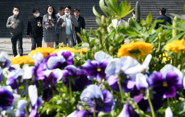 서울의 낮 기온이 17℃까지 오르는 등 포근한 봄 날씨를 보인 18일 시민들이 가벼운 옷차림으로 서울 광화문광장을 걷고 있다./오승현기자 2020.03.18